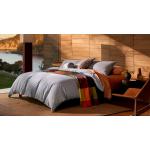 A bed with colourful bedding