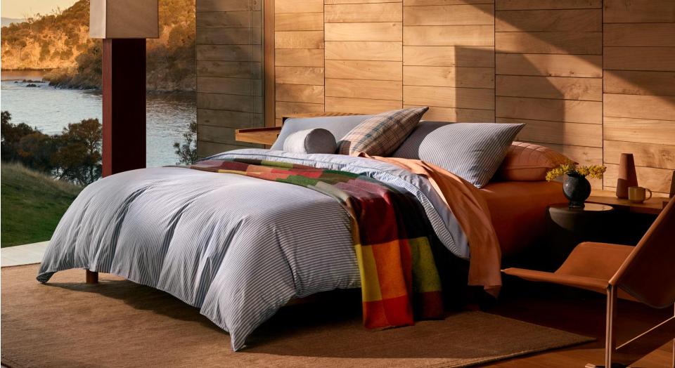 A bed with colourful bedding