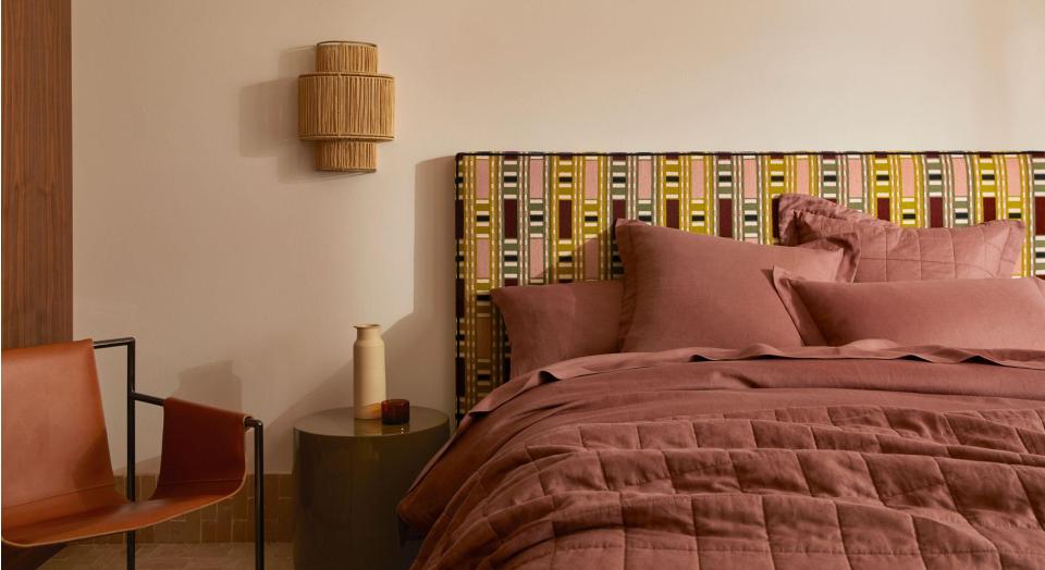 A bed with a geometric patterned fabric bed head.