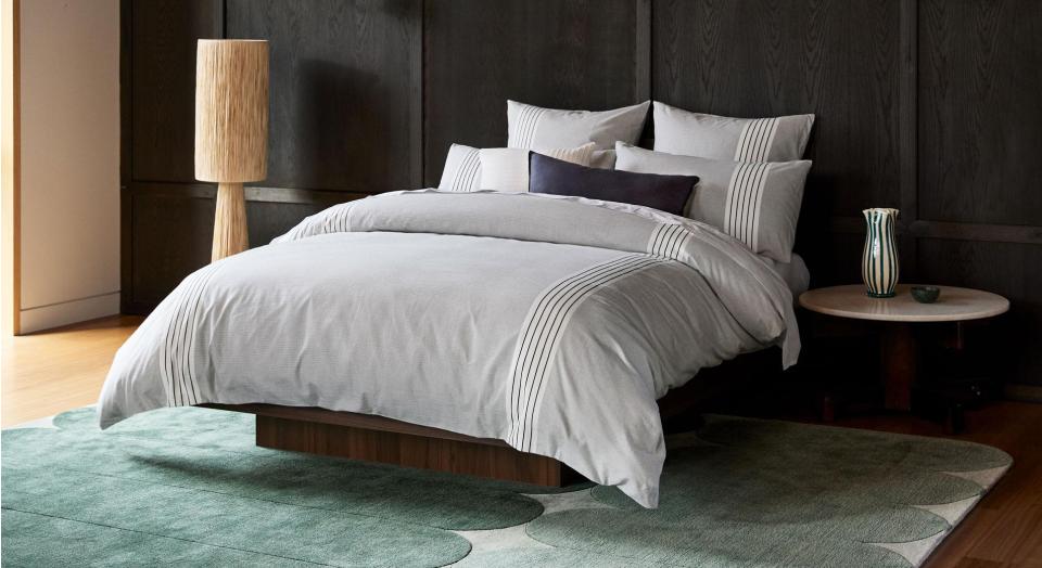 A monochrome bed in a modern bedroom