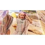 Two children walking on the beach wearing Sheridan Cancun beach ponchos
