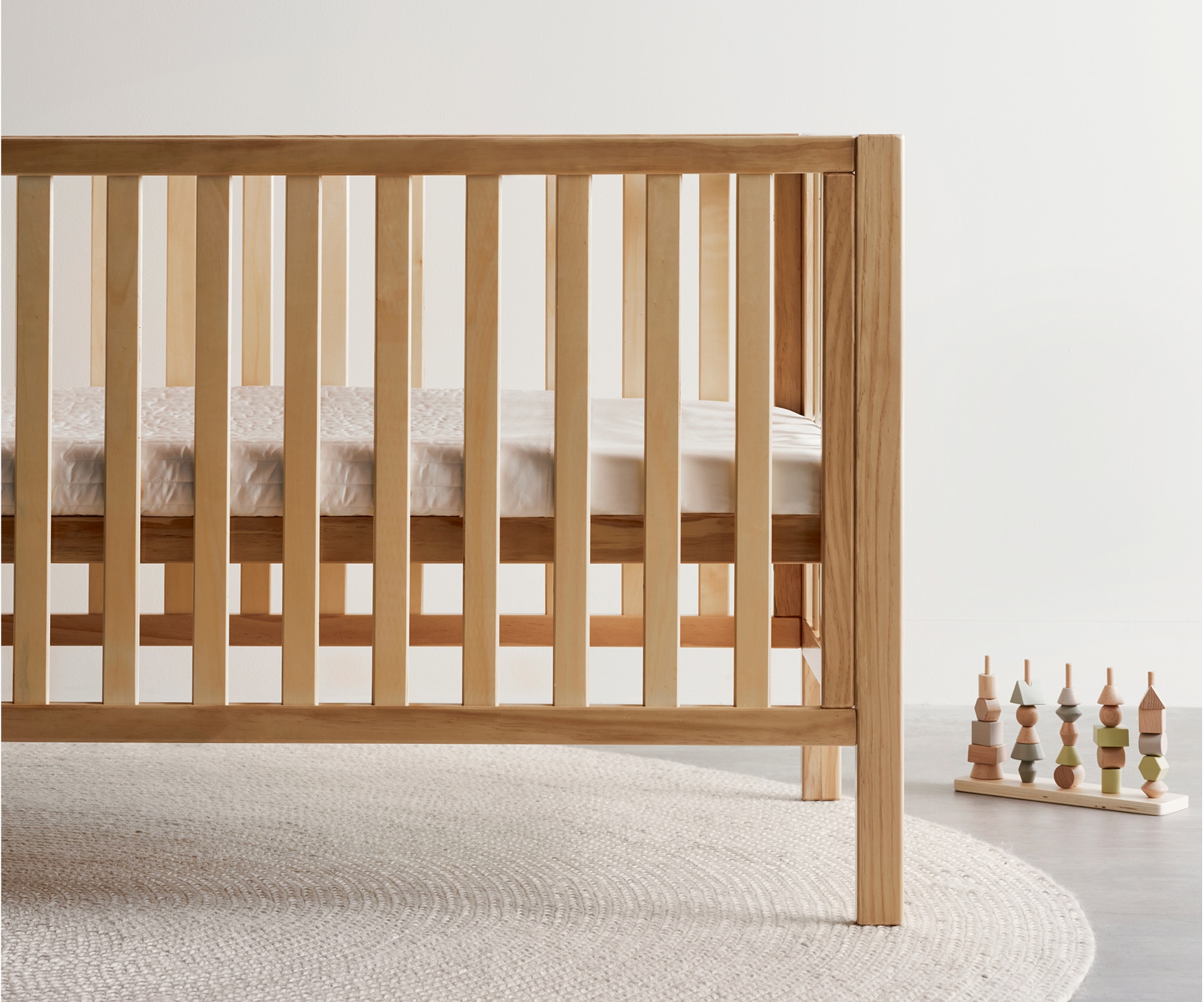 baby cot with mattress wooden baby toys in room