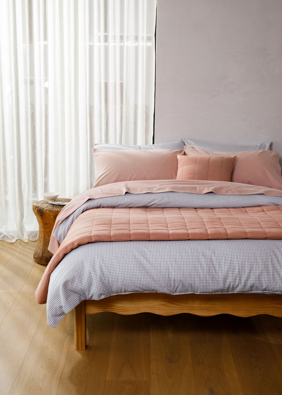 A bed made up with pink flannelette sheets