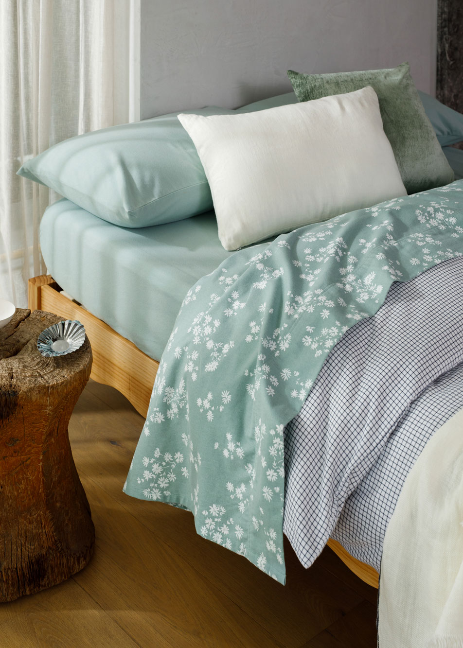 A bed made up with blue floral flannelette sheets