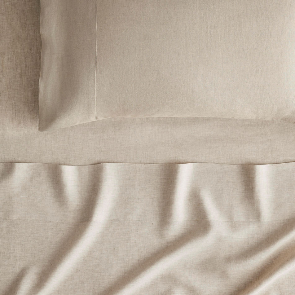 Close up photo of an Abbotson Linen sheet set in flax. A pillow sits on top.