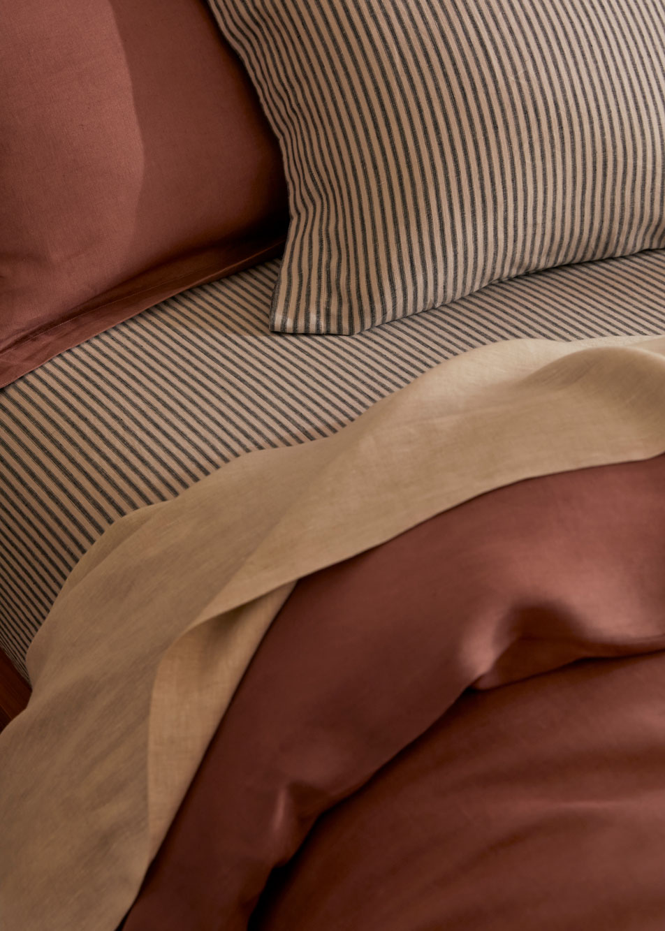 Close-up of a bed made up in different colours of Abbotson Linen