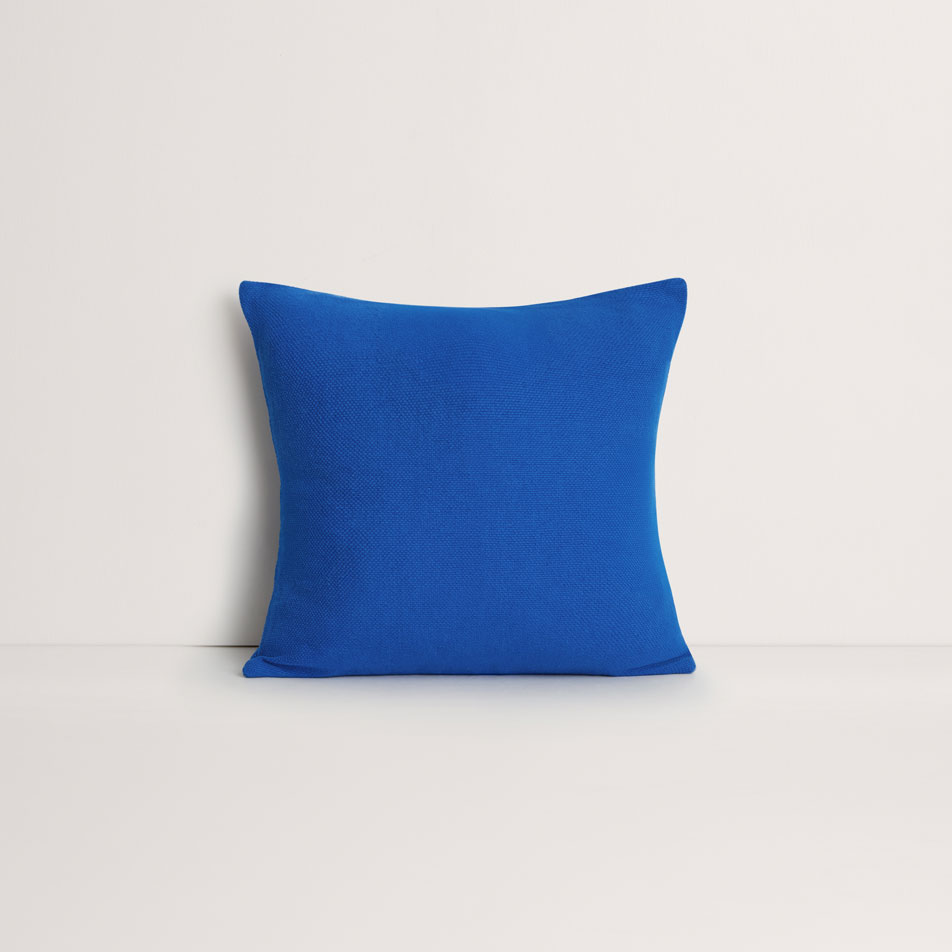 A flat lay image of an Adman square cushion in cobalt