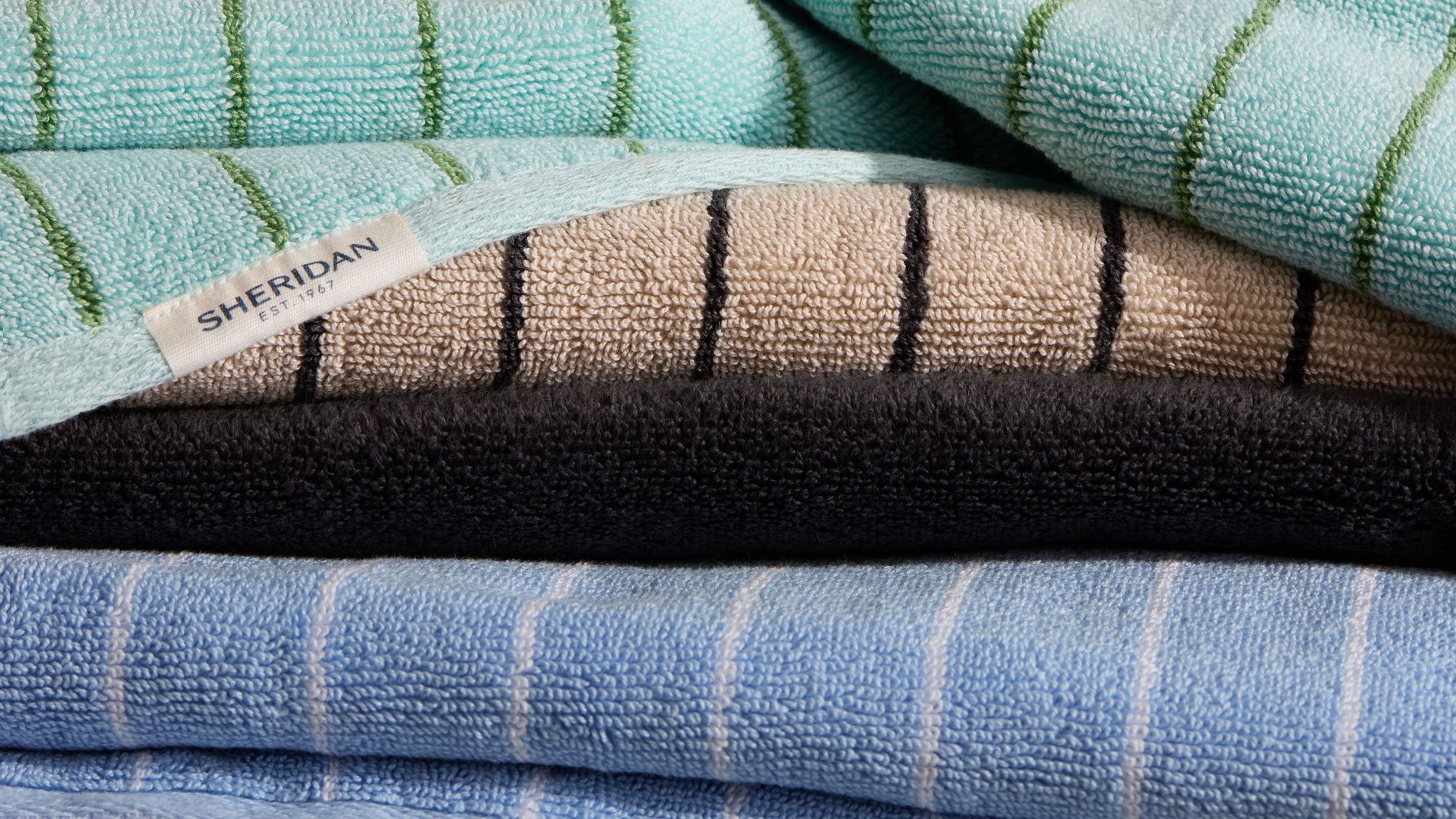 A close-up of a stack of Sheridan Aven australian cotton stripe towels