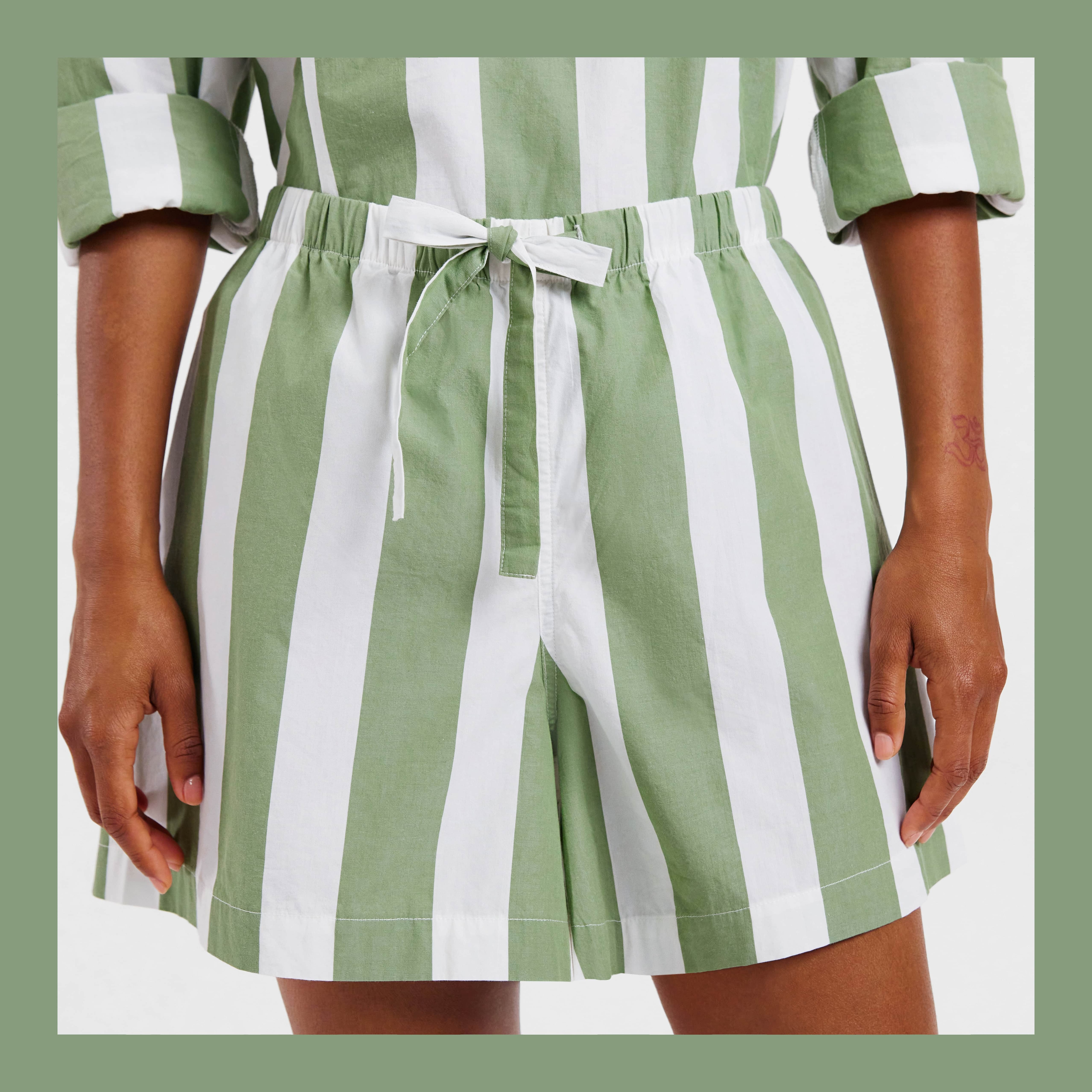 close up of striped green and white cypress short, on brown-skinned woman. bordered with green on all four sides. 