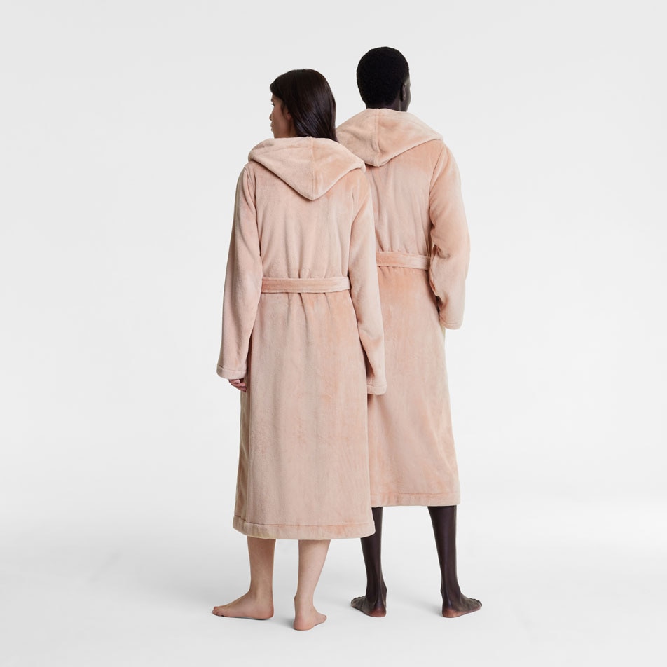 Two models wearing Elemental bathrobes stand in front of a white backdrop