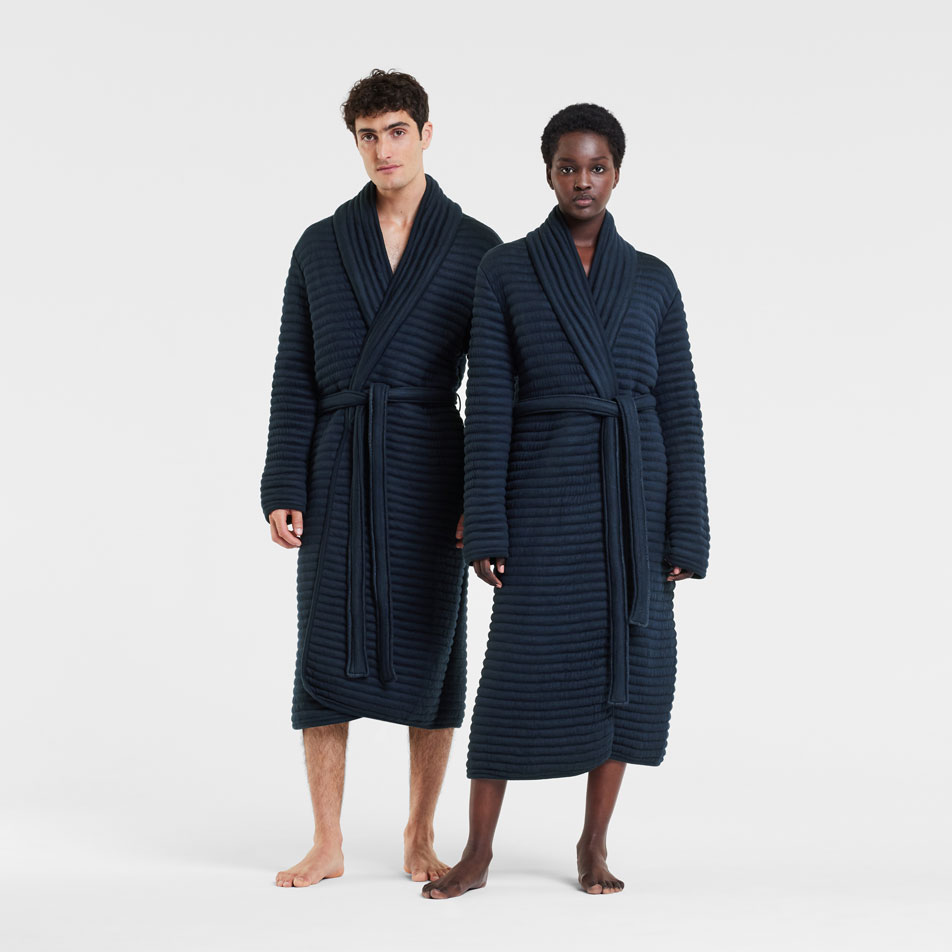 Two models wearing Enfold bathrobes stand in front of a white backdrop