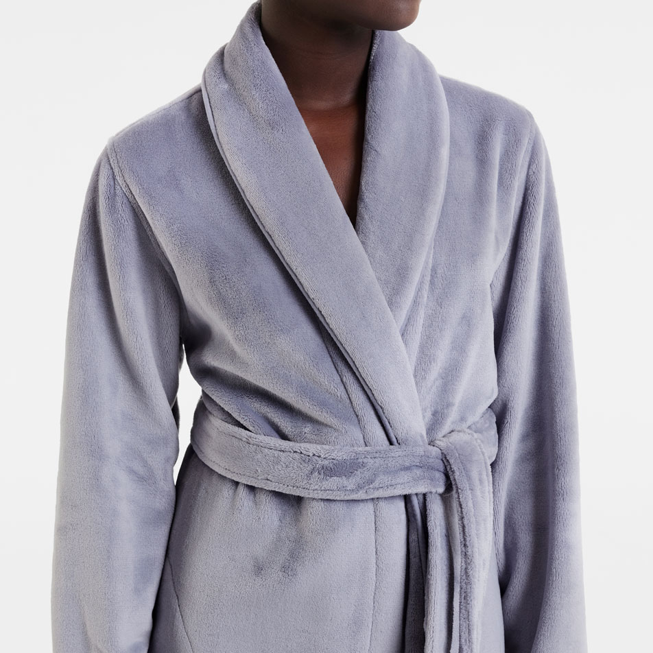 Close-up of a woman wearing a Kerrabee plush robe in the colour dappled grey