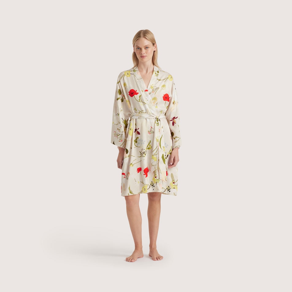 A model wearing a La Soie bathrobe in floral multi, standing in front of a white background