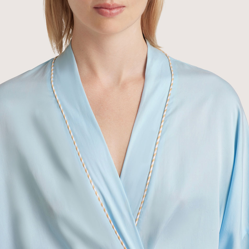Close-up of a model wearing a blue La Soie bathrobe