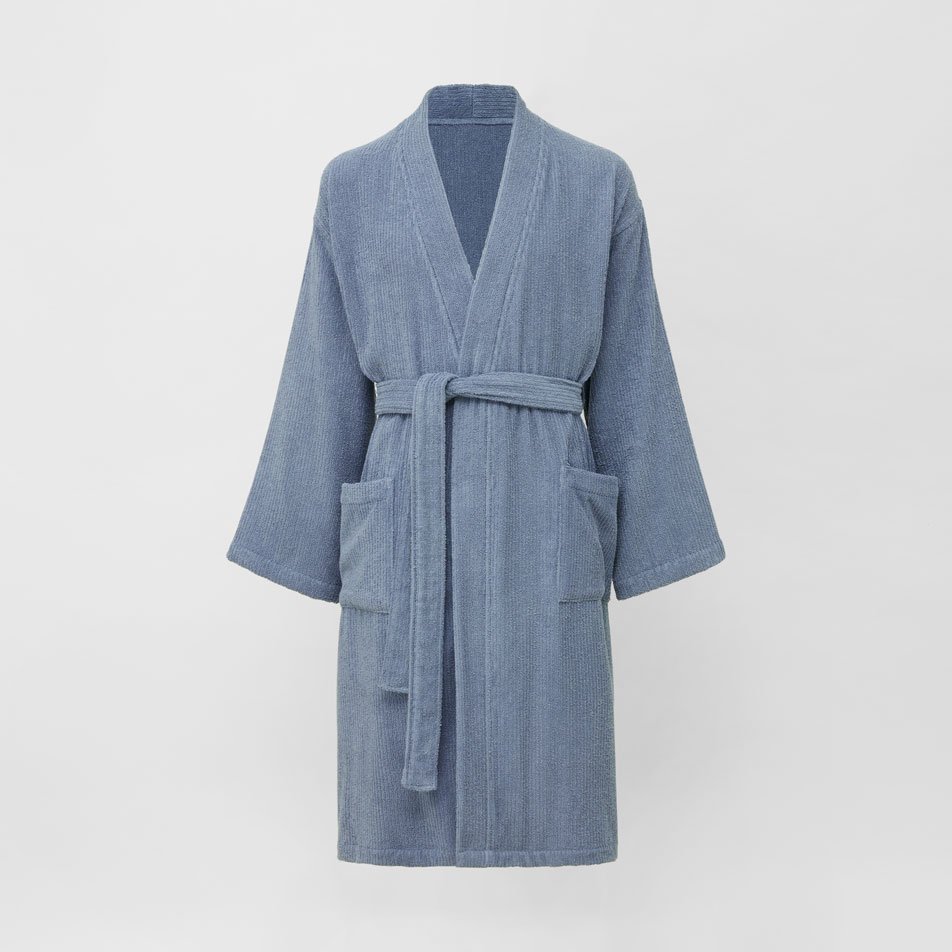 A flat lay image of a Sheridan Living Textures bathrobe in orient blue