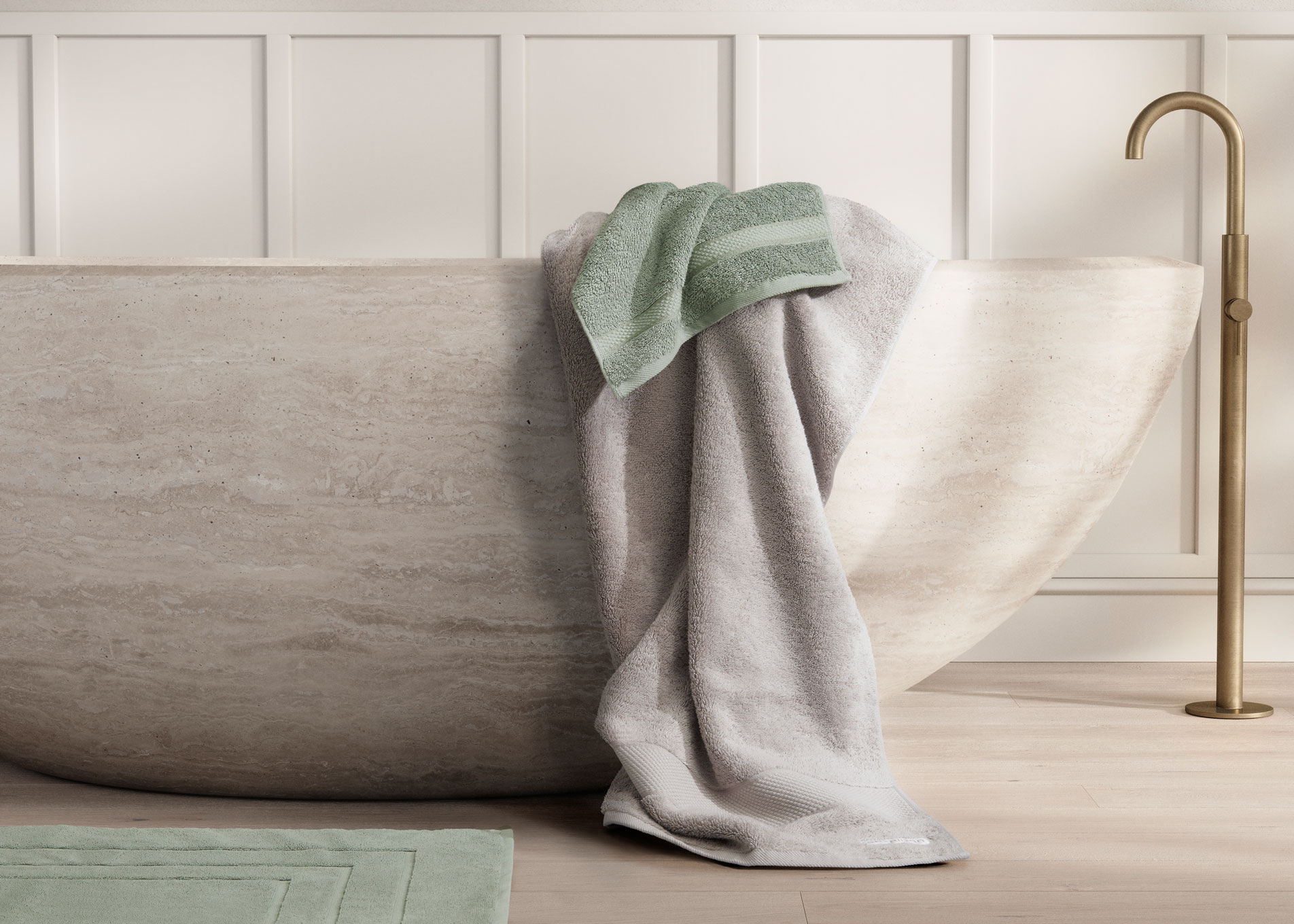sea green and grey bath towels hanging from modern concrete bath tub