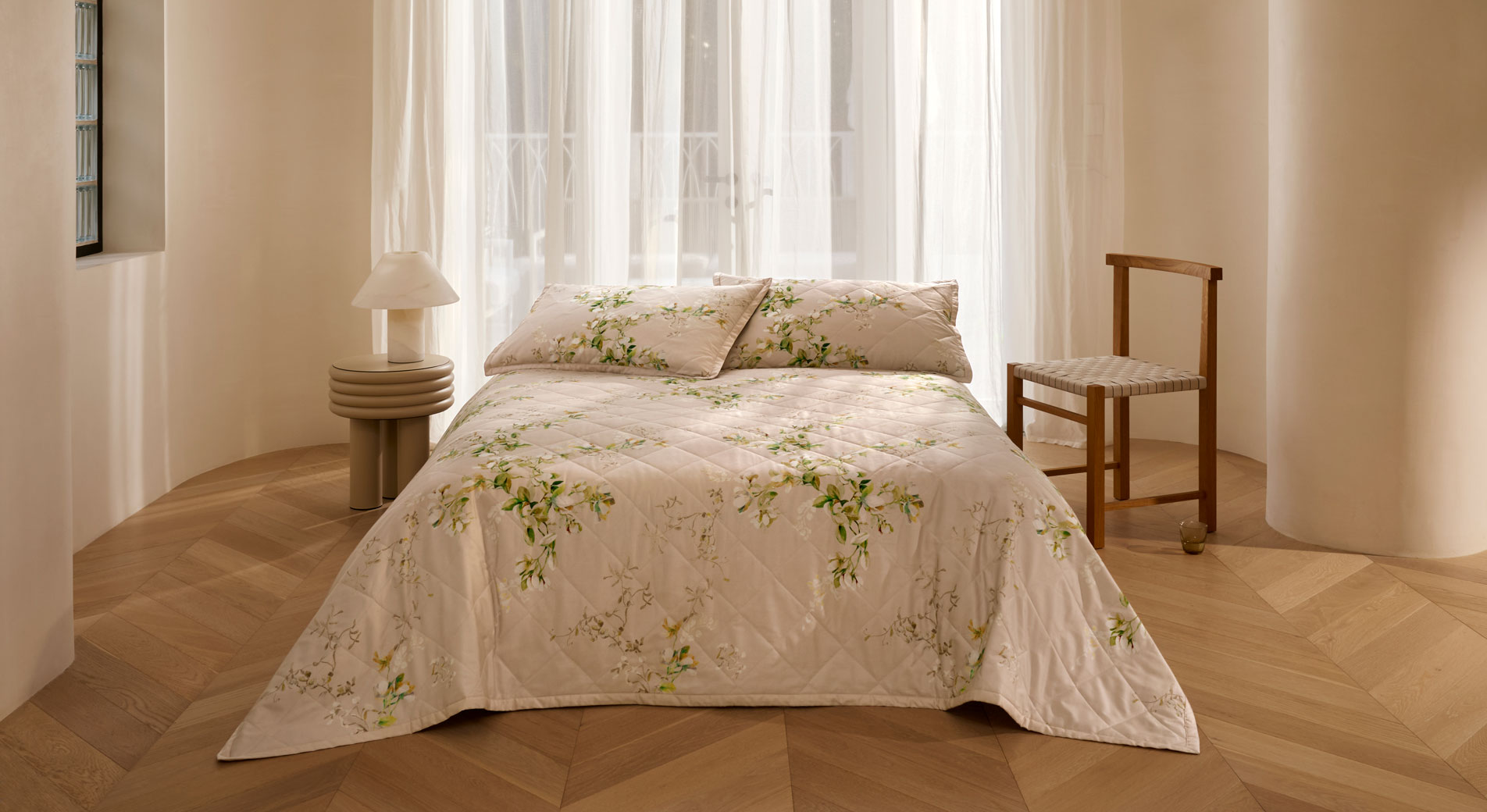 A a bed with floral sheets and pillowcases