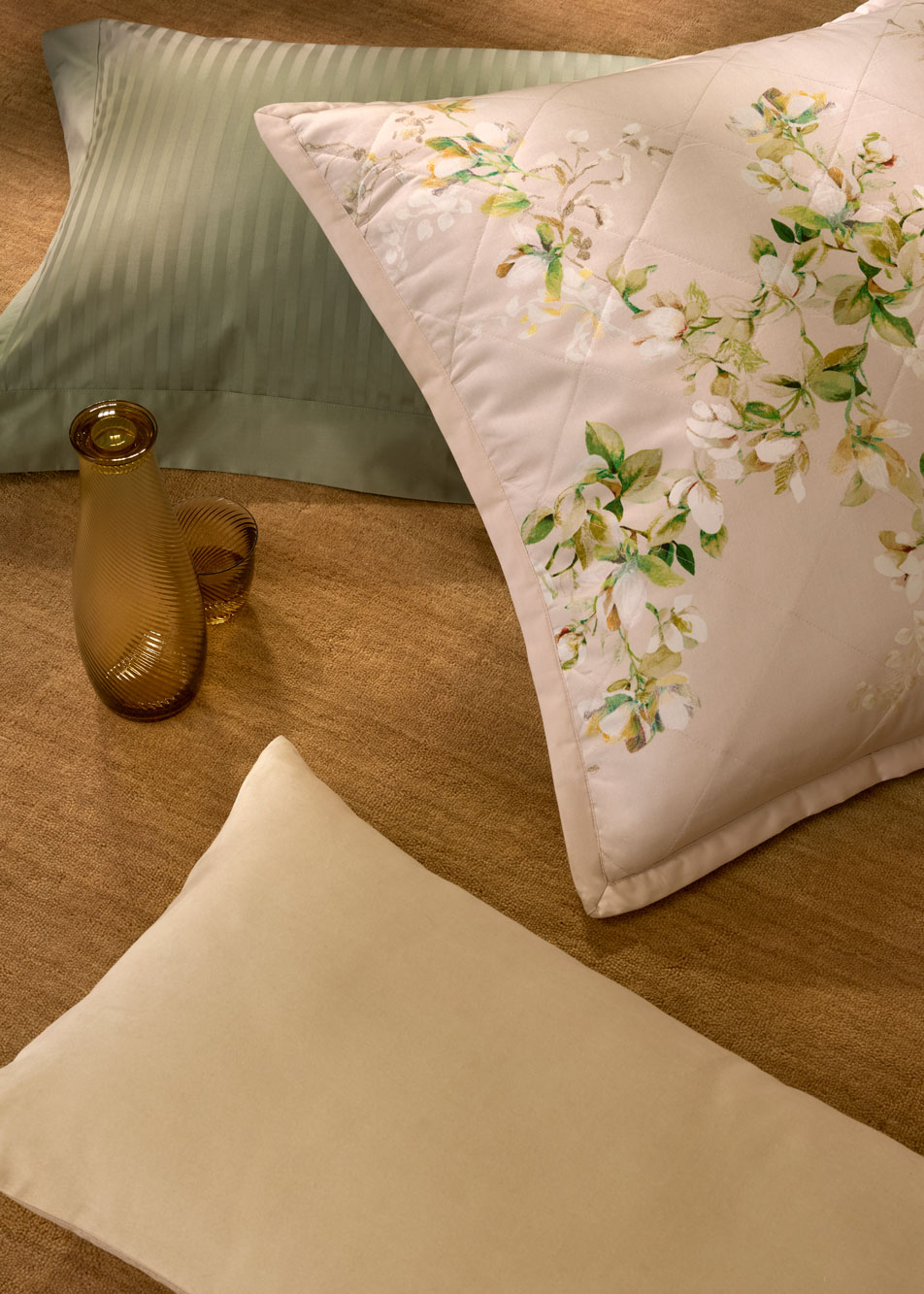 Three different pillows scattered on the floor