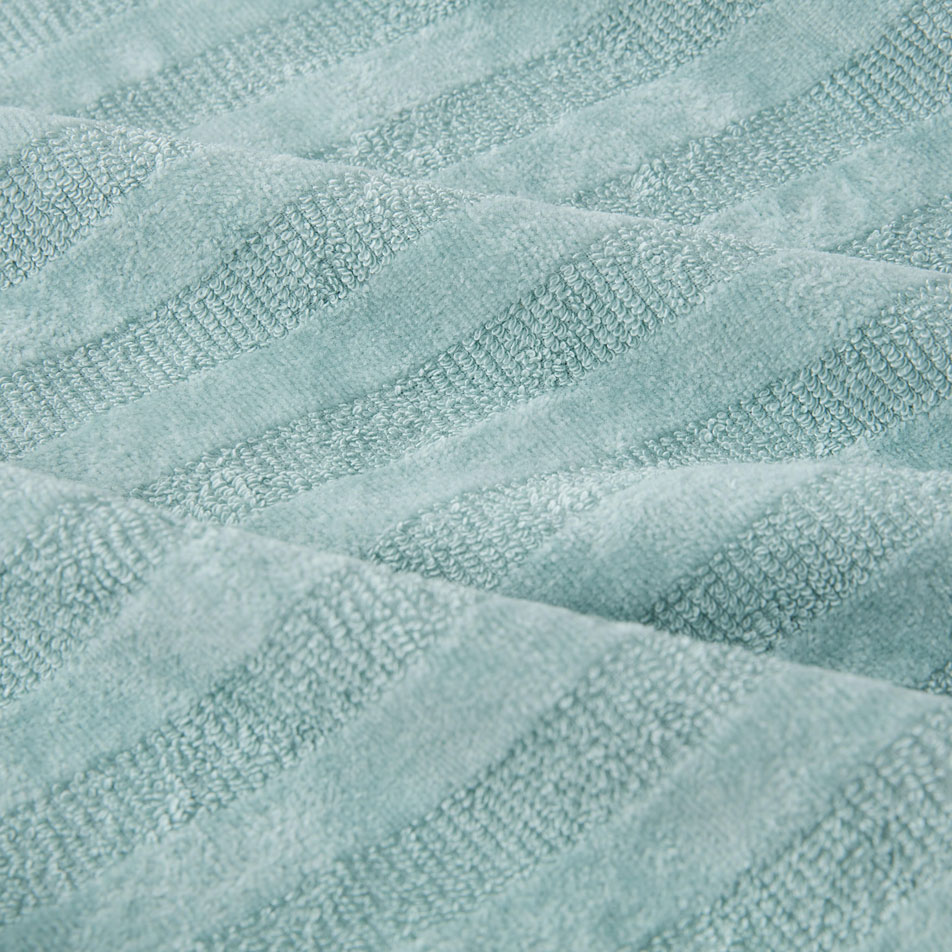 A close up image of light blue terry fabric, with textural stripes