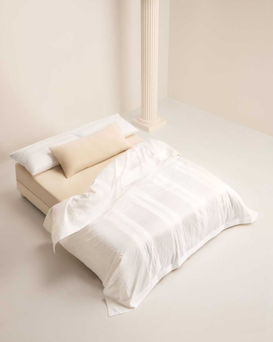 A birds eye view of a bed dressed in white Millennia sheets