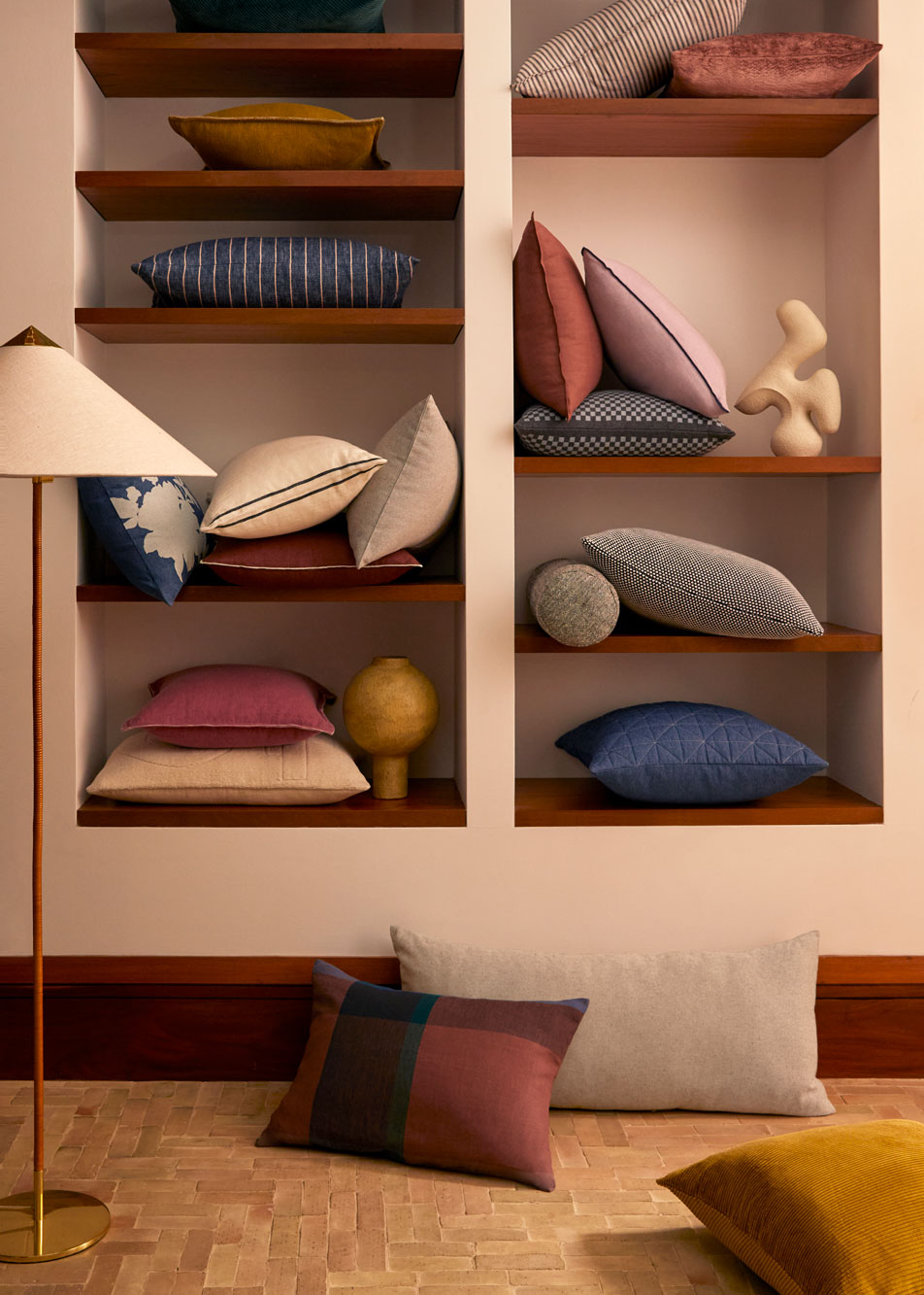 Built-in shelves with multiple cushions of different colours and sizes
