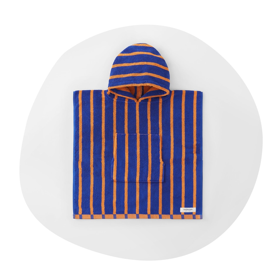 flatlay of sheridan baby pepin hooded poncho. dark blue hooded towel with orange stripes. the image is in an irregular circle shape, as if drawn by a child.