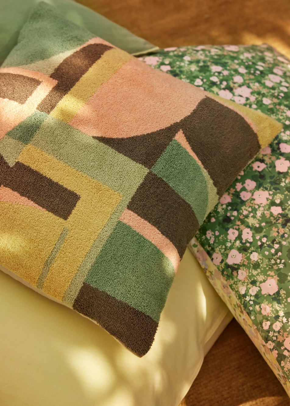 A close-up image of a stack of printed cushions
