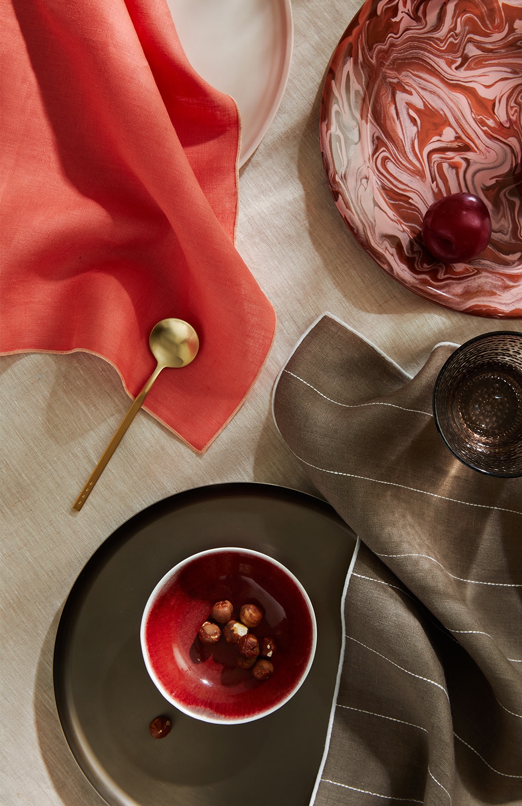 overhead shot of abbotson linen napkins in red and khaki stripe. set up for dinner party.