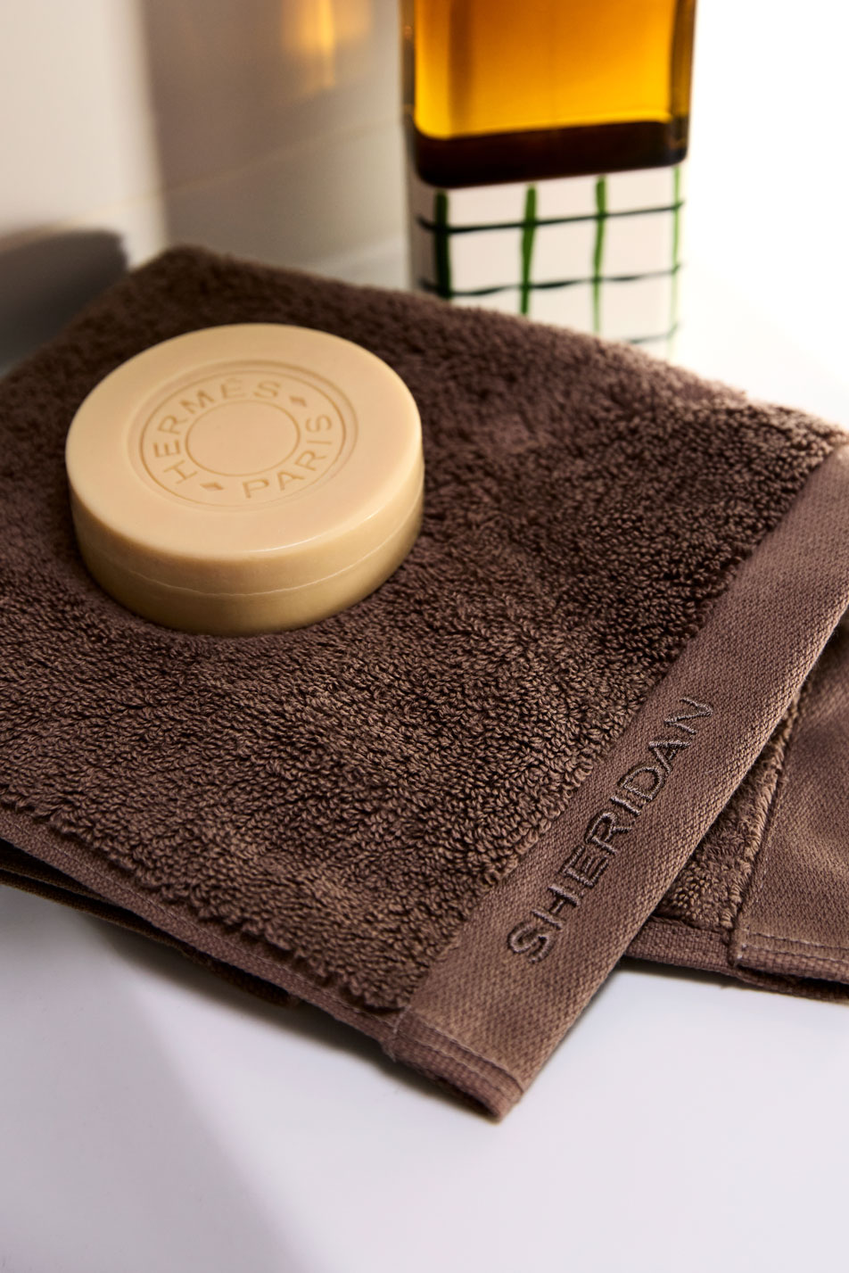 A brown Sheridan bath towel with a bar of soap sitting on top