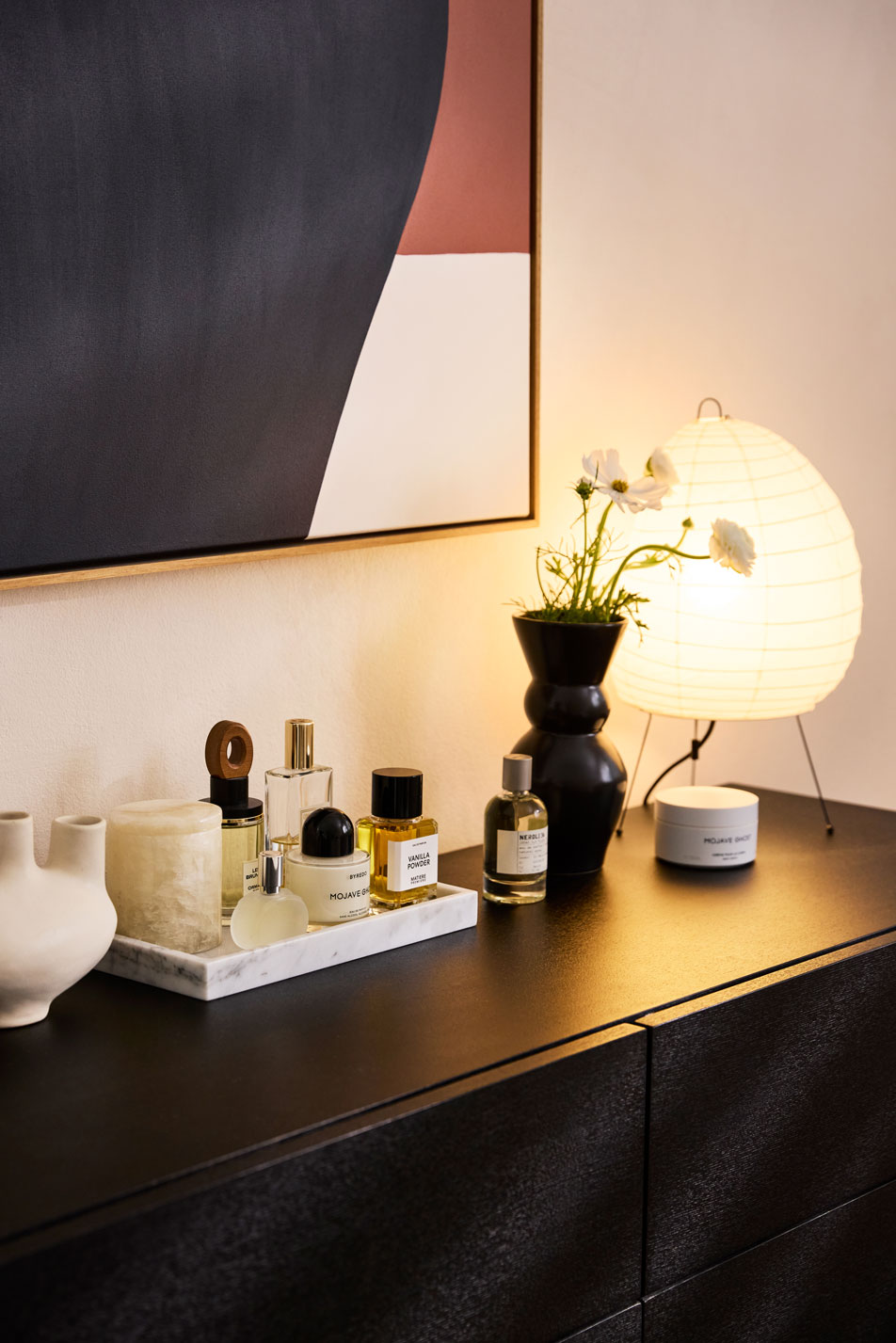 A brunette woman sitting on the edge of a kids' bed
