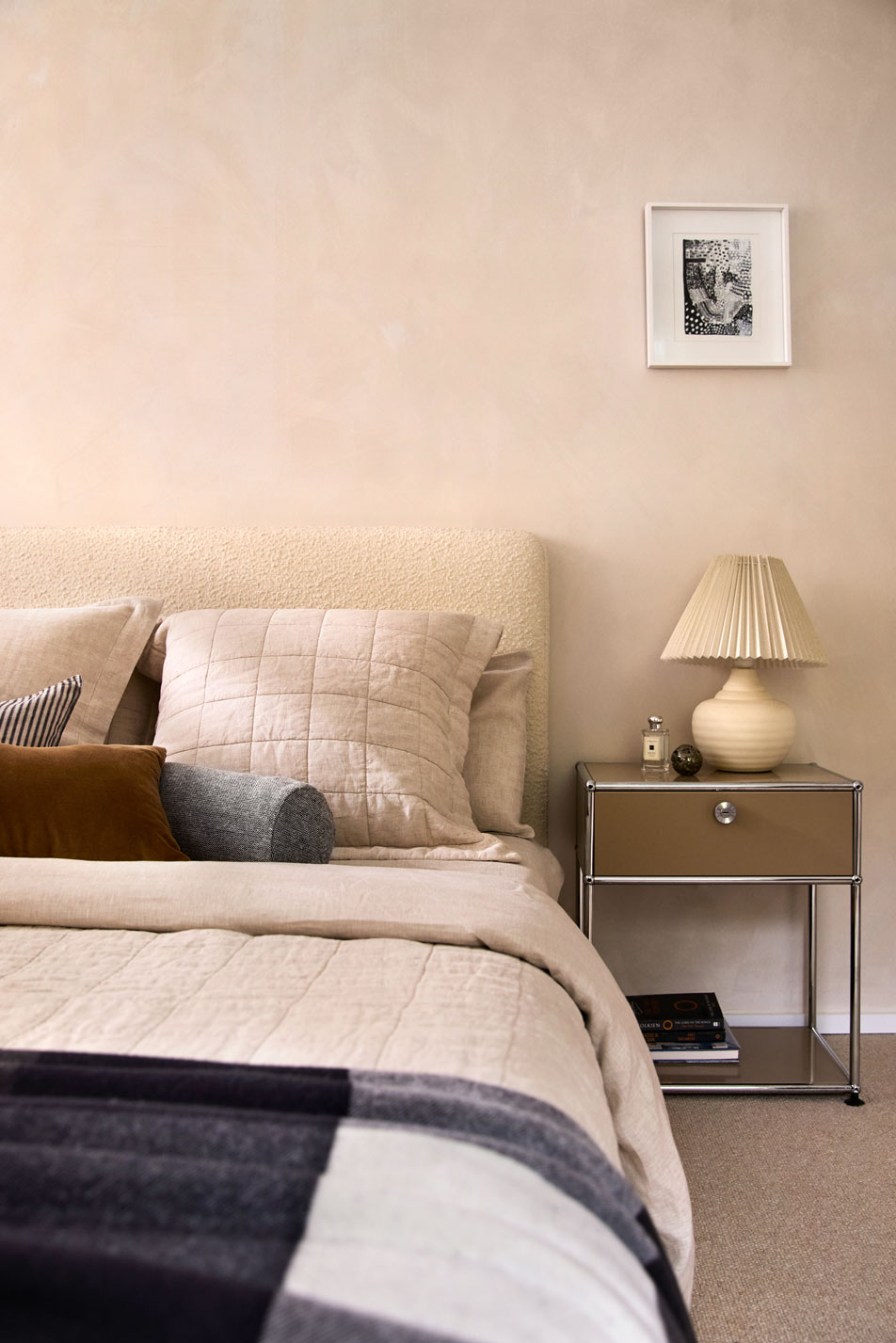 A brunette woman sitting on the edge of a kids' bed