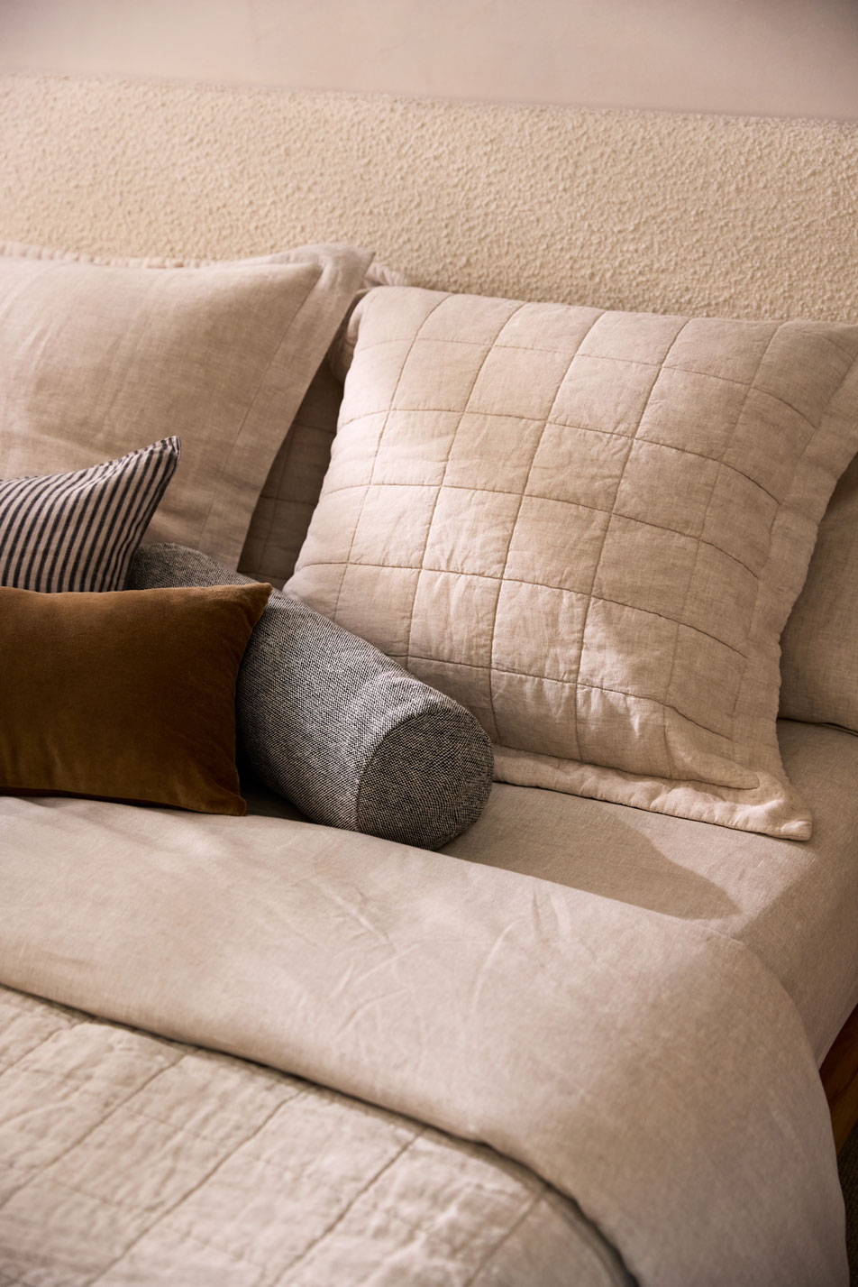 A side table in a children's bedroom. On top of the table is a vase and various toys.