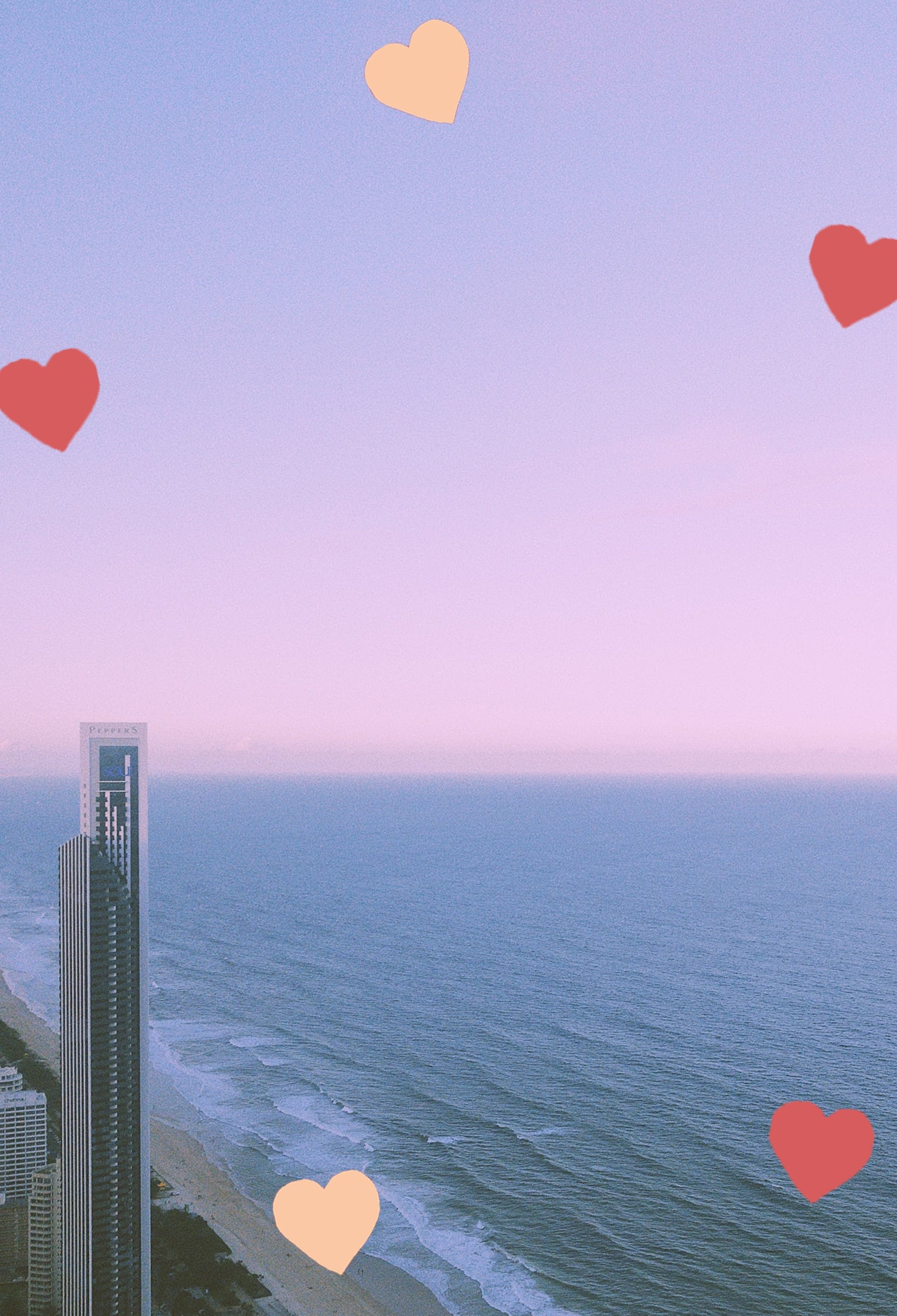 vertical shop of gold coast beach at sunrise, with hotel building in the left corner. scattered hearts decorate the image.