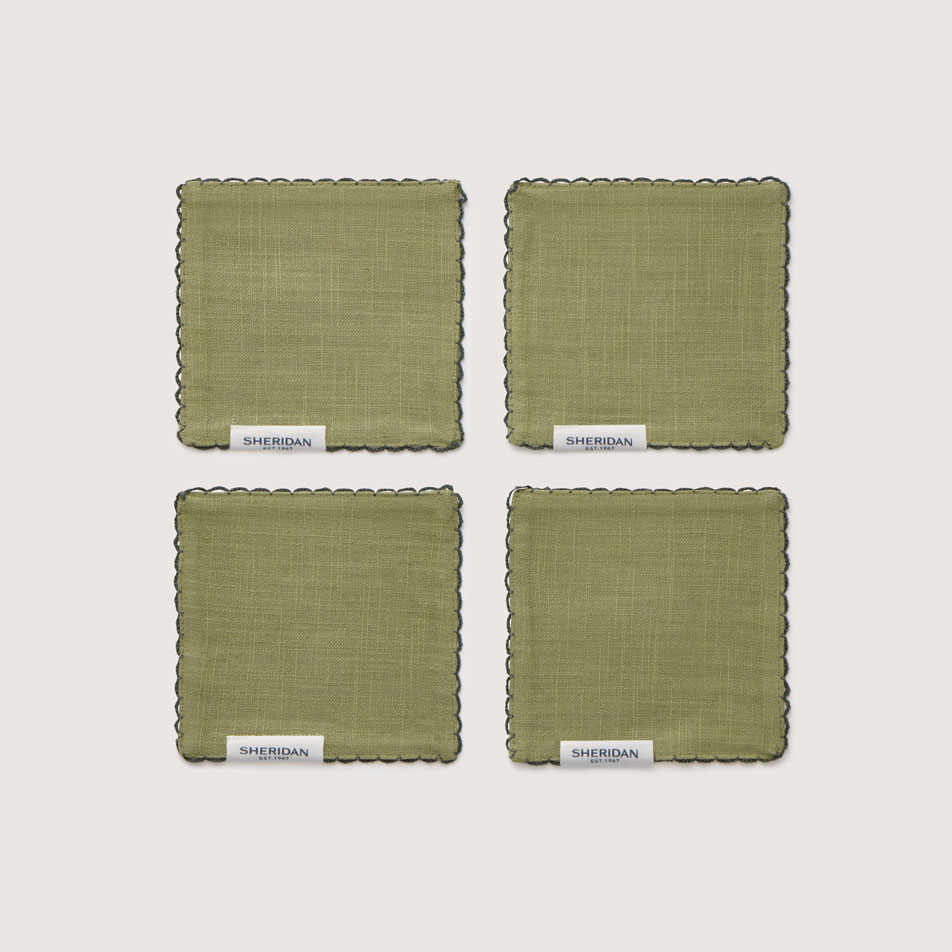 Flat lay image of four Vina fabric coasters in the colour garden