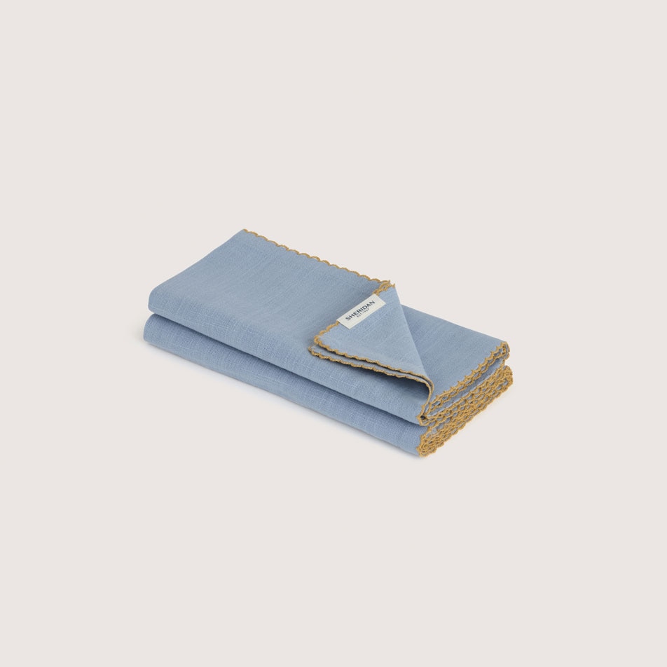 Two folded fabric napkins in the colour glacier