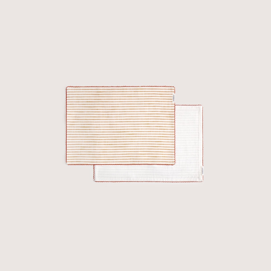 Flat lay image of two Vina fabric placemats in the colour caramel